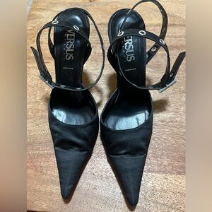 Versace iconic black satin heels with ankle wrap grommets.